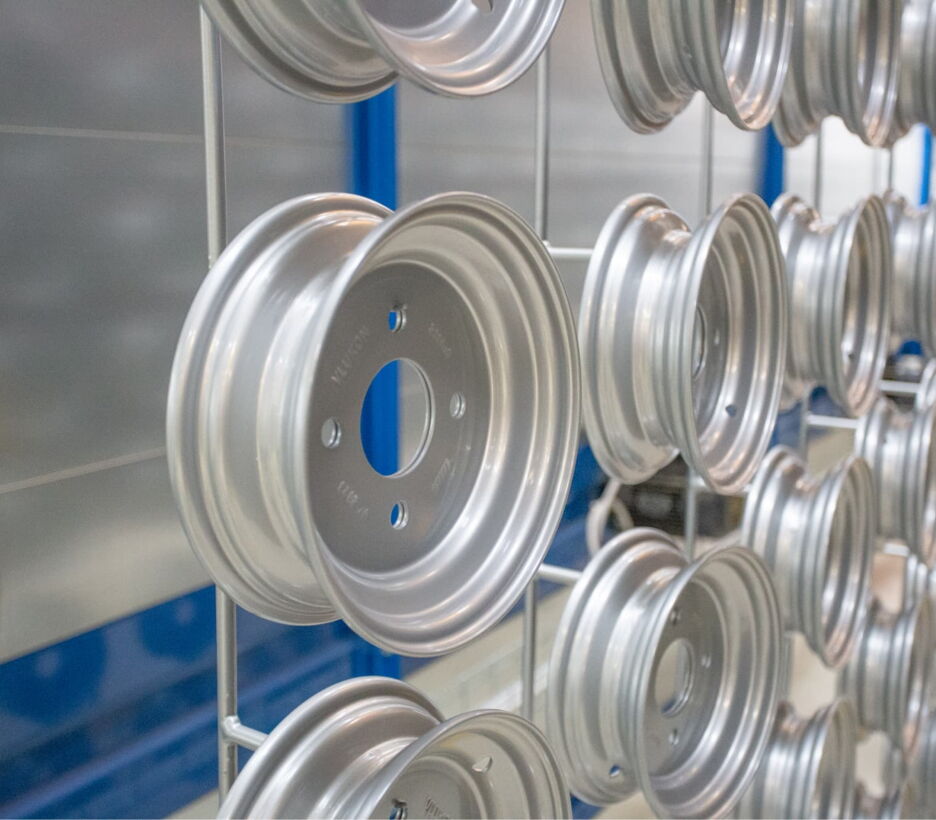 Steel wheel rims on a rack after surface treatment