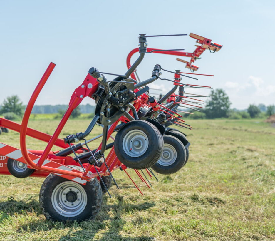 Hay tedder with steel rim wheels in a field