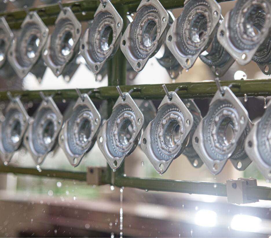 Swivel castor housings on a plating rack after zinc electroplating