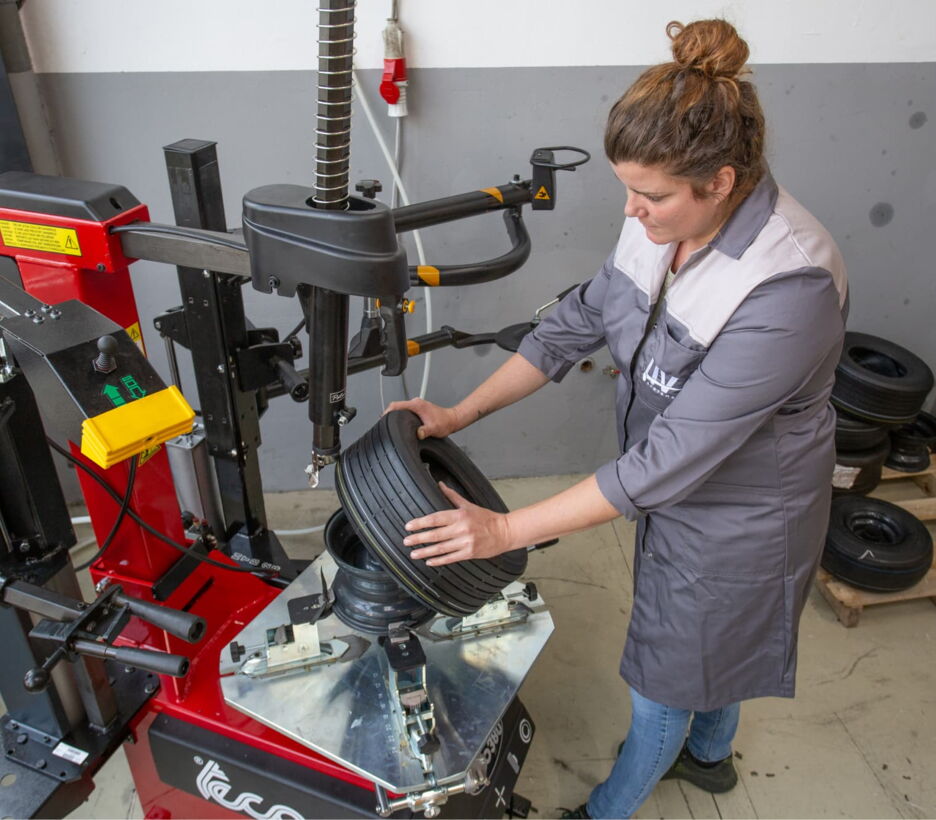 LIV employee mounting a tyre on a steel rim